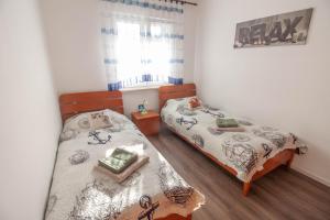Łóżko lub łóżka w pokoju w obiekcie Apartment Nolan