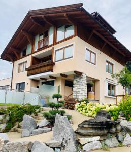 a house with a rock garden in front of it at Ferienwohnung Ingrid Hörbiger in Mittersill