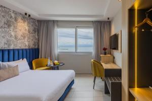 a hotel room with a bed and a desk at Kenzi Solazur in Tangier