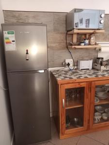 a kitchen with a stainless steel refrigerator and a counter at Scholtz Self-catering Accommodation in Lüderitz