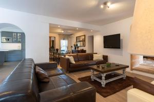 a living room with a leather couch and a table at Villa Monsebo by Slow Villas in Algaida +37 photos