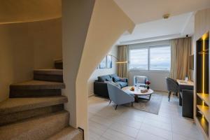 a living room with a couch and a table and stairs at Kenzi Solazur in Tangier
