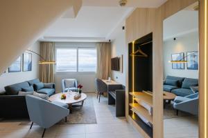 a living room with a couch and a table at Kenzi Solazur in Tangier