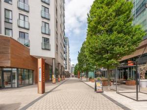 an empty street in a city with tall buildings at Pass the Keys Waterfront Serenity Leeds Dock Christmas Views in Leeds