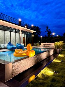 a house with a swimming pool with inflatable animals in it at NADON VILLA in Ban Choko