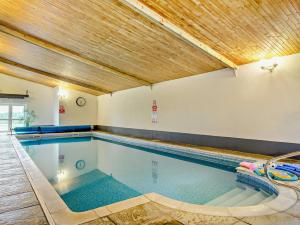 a large swimming pool with a wooden ceiling at 3 Bed in Totnes 51955 in Ipplepen