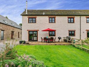 a house with a patio with a table and chairs at 3 Bed in Totnes 51955 in Ipplepen