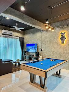 a living room with a pool table in it at NADON VILLA in Ban Choko