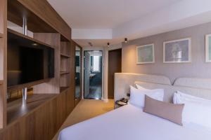 a hotel room with a bed and a flat screen tv at Kenzi Solazur in Tangier
