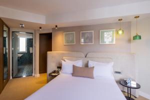 a bedroom with a large bed with white pillows at Kenzi Solazur in Tangier
