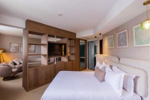 a bedroom with a white bed and a television at Kenzi Solazur in Tangier