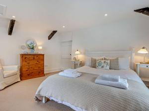 a bedroom with a large bed with two towels on it at 3 bed property in Bude 53607 in Jacobstow