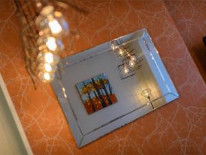 a mirror on a table with flowers in a room at 2 Bed in Harrogate HH052 in Harrogate