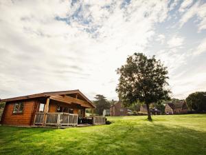 a log cabin in a field with a tree at 1 bed in Bishops Frome 75600 in Bishops Frome