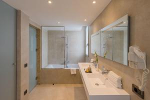 a bathroom with a tub and a sink and a shower at Kenzi Solazur in Tangier
