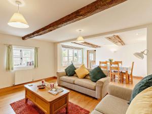 a living room with a couch and a table at 3 Bed in Church Stretton 76621 in Rushbury