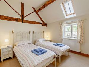 two twin beds in a bedroom with a window at 3 Bed in Church Stretton 76621 in Rushbury