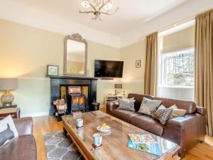 a living room with a couch and a fireplace at 4 bed in Loch Lomond 78669 in Stronachlachar