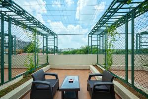 a room with chairs and a table on a roof at Flora Airport Hotel and Convention Centre Kochi in Nedumbassery