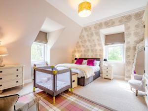 a bedroom with a bed with pink pillows at 4 bed in Loch Lomond 78669 in Stronachlachar