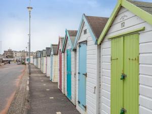 a row of beach huts lined up on a street at 1 bed in Paignton 78200 in Paignton