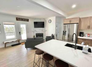 a kitchen and living room with a refrigerator and a table at Relaxing 3 bedroom suite, near Silver Star Resort in Vernon