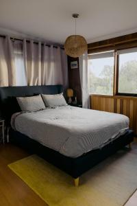 a bedroom with a large bed and a window at The Sandy Sister in Dodges Ferry