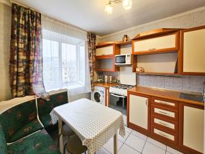 a small kitchen with a table and a couch and a window at Nadezhda Apartments on Gogol st. - Maulenov st. in Almaty