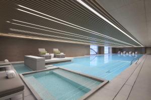 a large swimming pool in a building at Wenzhou Marriott Hotel in Wenzhou