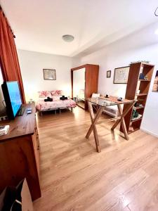 a living room with a bed and a table at Suite bike with parking in Trieste