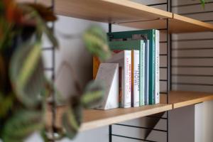 una fila di libri su una mensola di Beautifully renovated 1BR Flat in Walthamstow a Londra