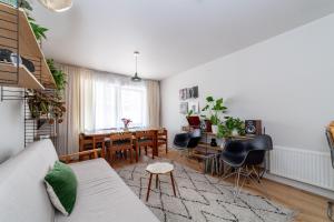 a living room with a couch and a table and chairs at Beautifully renovated 1BR Flat in Walthamstow in London