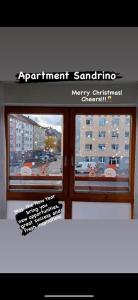 a window with a sign that reads apartment santenna merry christchurchchurch at Apartment, Messe 5 min., City 3 min., wifi in Nuremberg