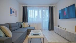 a living room with a couch and a table at Mountain Hideaway Apartment in Braşov