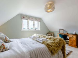 a bedroom with a bed and a dresser and a window at 1 Bed in Hereford 83703 in Wormbridge