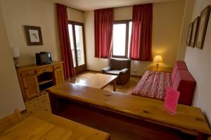 a living room with a couch and a table at Apartamentos Pessets Adelaida in Sort +20 photos