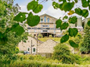 a building with a sign on it in the distance at 1 bed in Masham 85511 in Masham