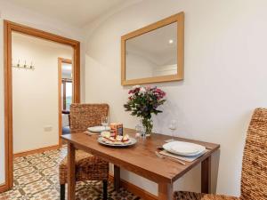 a dining room with a table and a mirror at 1 Bed in Liskeard 85888 in Saint Neot