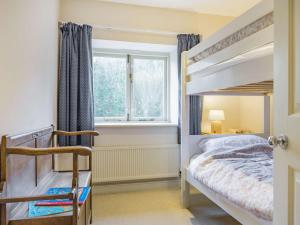 a bedroom with a bunk bed and a window at 2 Bed in Gilwern 86615 in Gilwern