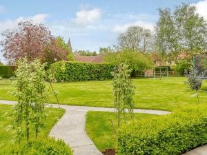 twee bomen in een tuin met een gazon bij 1 bed property in York 87323 in Green Hammerton