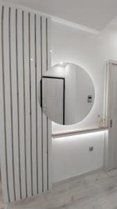 a white refrigerator with a mirror on a wall at The Golden home 1 in Piraeus