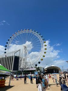 a ferris wheel on a beach with a crowd of people at The Mark Sokcho Residence #16 Level in Sokcho