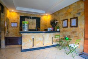 a bar in a room with a table and chairs at BS Home in Kuta