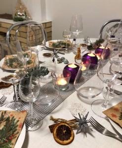 a table with wine glasses and christmas decorations on it at Загородный дом на берегу реки Самара in Dnipro