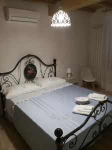 a bedroom with a large bed with a black frame at SOSTA SANT'ANTONIO in Pisa