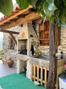 an outdoor kitchen with a stone oven in a yard at Villa de Fujacos in Valença