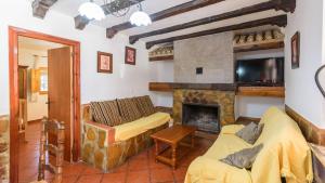 a living room with a couch and a fireplace at Casa de Paquita Montefrio by Ruralidays in Montefrío