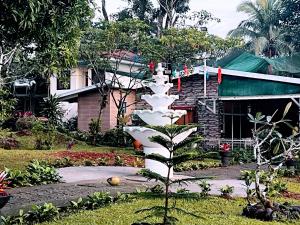 a sculpture of a plant in front of a house at BALAI BANAHAW Vacation Farm and Private Resort in Lucban
