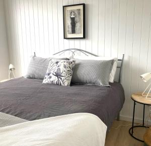 a bed with two pillows on it in a bedroom at Bridairre in Bridport