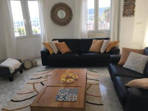 a living room with a couch and a coffee table at Casa La Vida, stijlvolle Spaanse villa met uniek uitzicht! in Benitachell